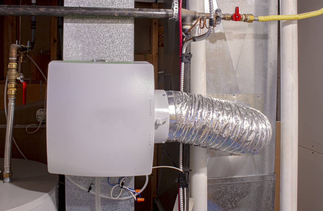 A home humidifier installation attached to the return duct with a bypass connection to the supply air duct.